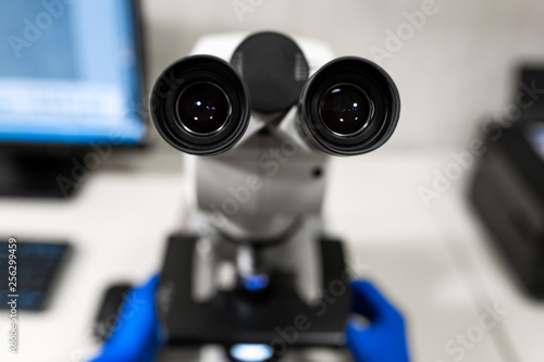 Fototapeta Naklejka Na Ścianę i Meble -  Closeup point of view of laboratory assistant looking through microscope lens