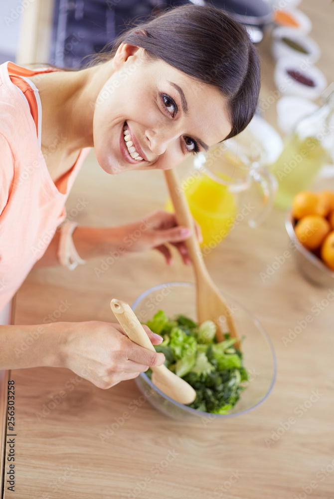 Young woman in the kitchen preparing a food Young woman in the kitchen preparing a food