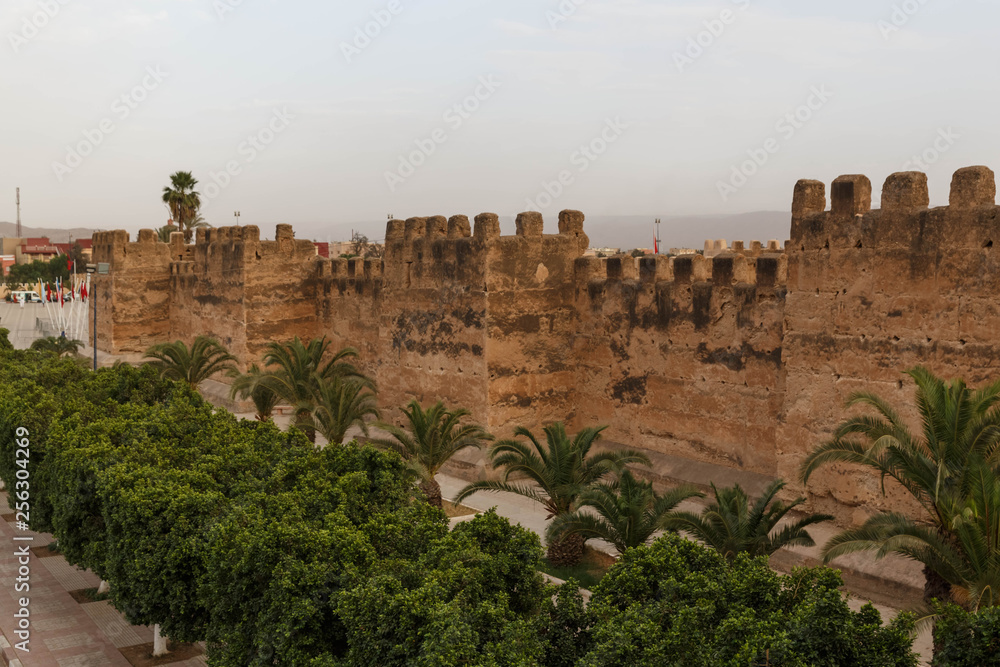 Taroudant old medieval defensive wall and palms alley, Morocco