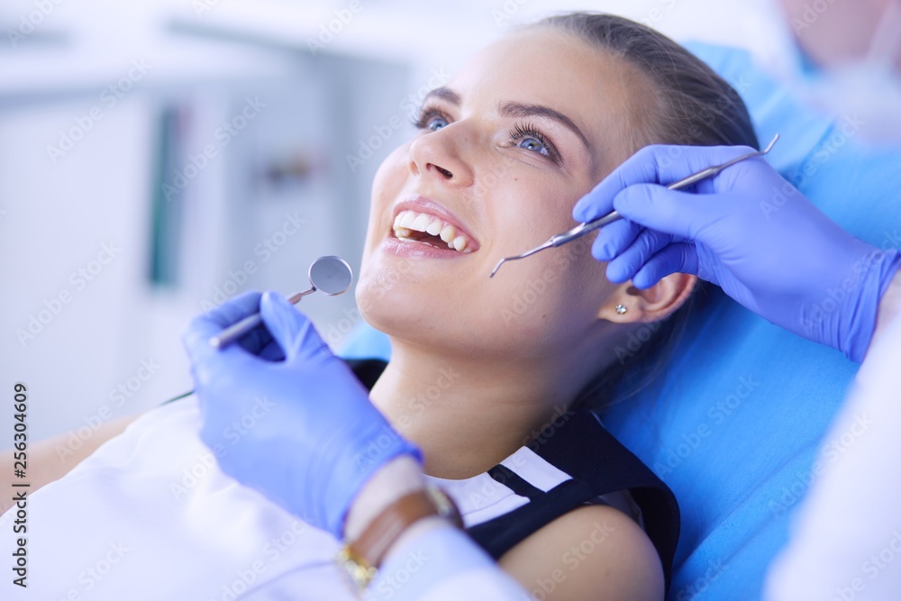 Young Female patient with open mouth examining dental inspection at dentist office. Young Female patient with open mouth examining dental inspection at dentist office.
