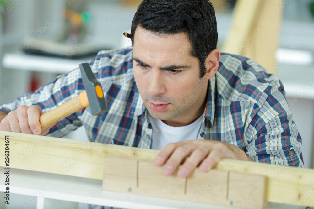 man hammering small nails man hammering small nails