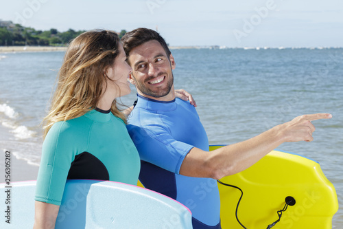 young couple of bodyboard surfers