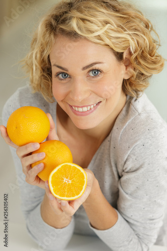 happy young woman with oranges