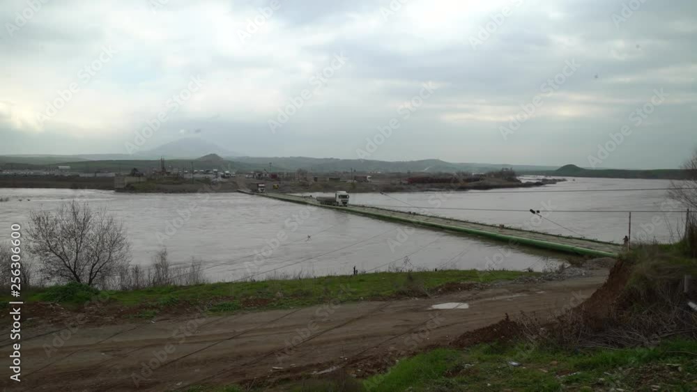 Syrian trucks crossing floating bridge 2 Syrian trucks crossing floating bridge 2