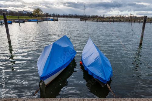Two covered boats in a small harbour of Hard on Lake Constance