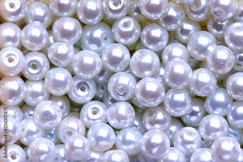 Background of white decorative pearls close-up.
