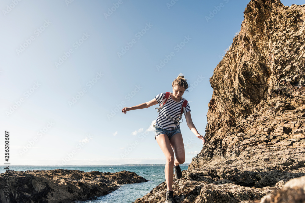 Young woman hiking on a rocky beach Young woman hiking on a rocky beach