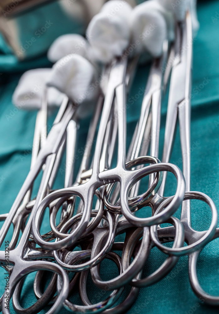 Scissors surgical with torundas on a tray metal in an operating theater, conceptual image Scissors surgical with torundas on a tray metal in an operating theater, conceptual image