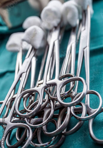 Scissors surgical with torundas on a tray metal in an operating theater, conceptual image photo