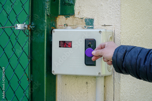 Door access control with a hand inserting key card to lock and unlock door.
