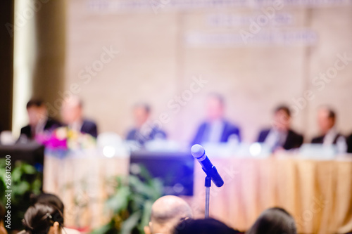 фотографія Blurry of microphone with chairman of the meeting and executive committee backgr