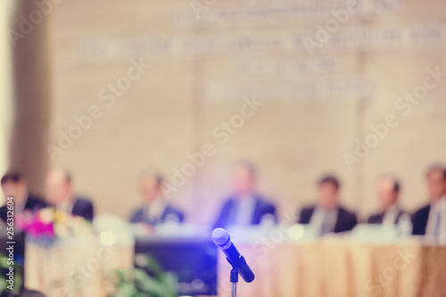 Fototapeta Blurry of microphone with chairman of the meeting and executive committee backgr