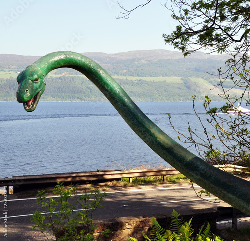 peeking head and neck of the monster on the background of nature
