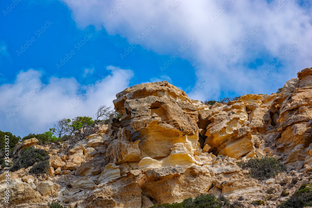 Nice rock texture with blue sky and clouds.