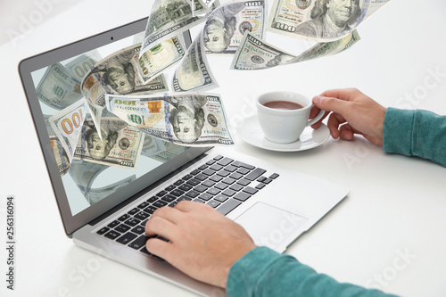 Young man working with modern laptop at table, closeup. Mockup for design photo