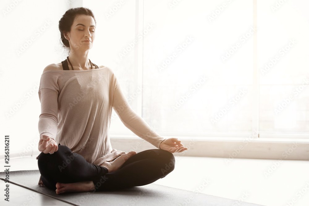 Sporty woman practicing yoga indoors Sporty woman practicing yoga indoors