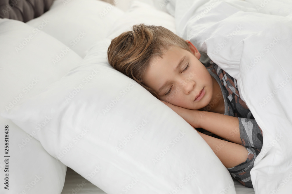 Cute tired boy sleeping in comfortable bed Cute tired boy sleeping in comfortable bed