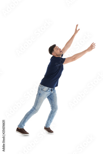 Emotional man in casual clothes posing on white background