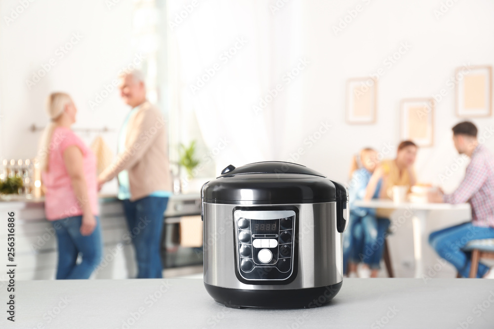 Modern multi cooker on table in kitchen Modern multi cooker on table in kitchen
