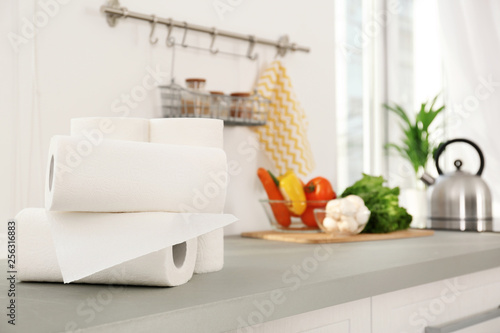 Rolls of paper towels on table in kitchen photo