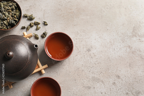 Flat lay composition with cups of Tie Guan Yin oolong tea and space for text on table photo