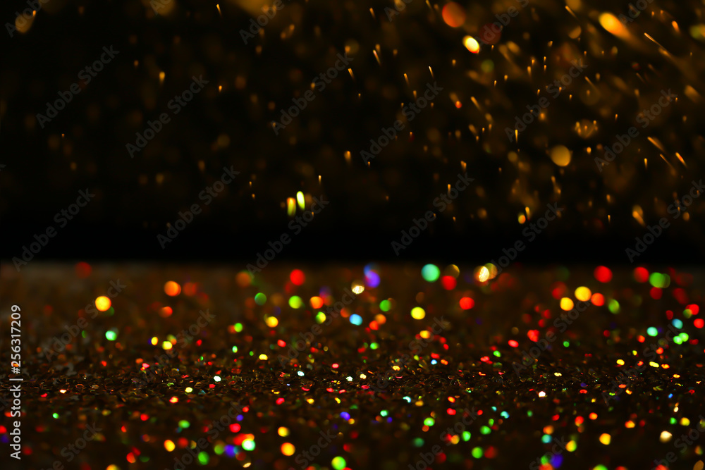Many golden paillettes against black background. Space for text Many golden paillettes against black background. Space for text