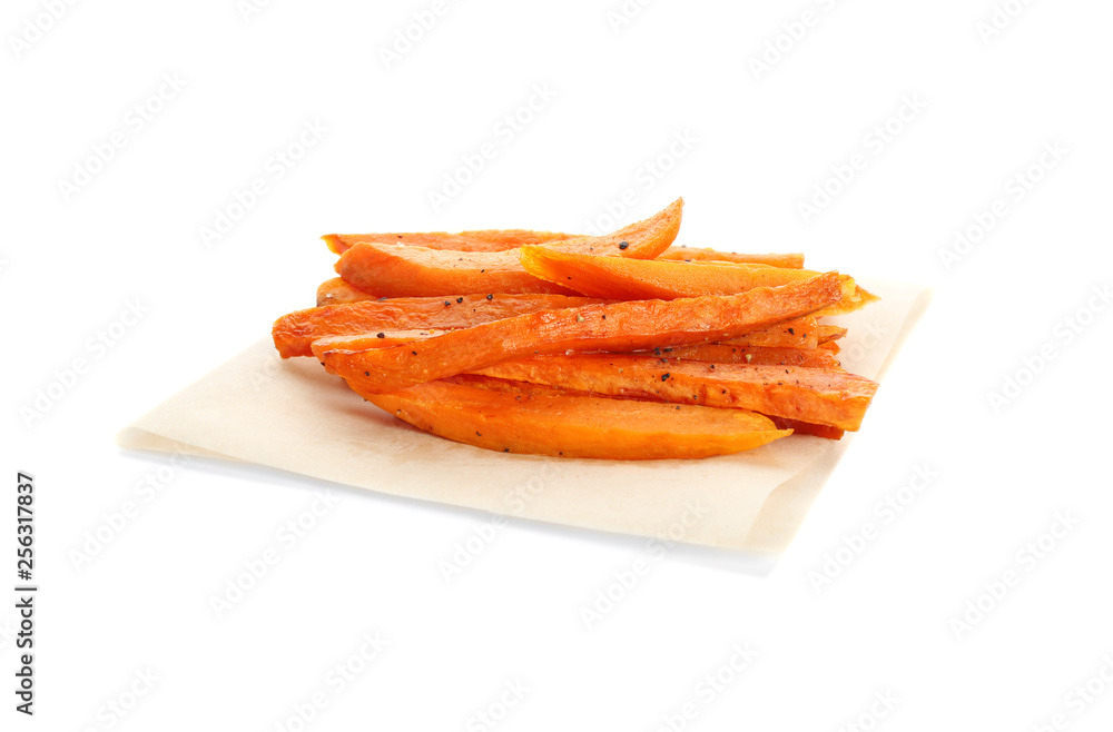 Parchment with tasty sweet potato fries on white background Parchment with tasty sweet potato fries on white background