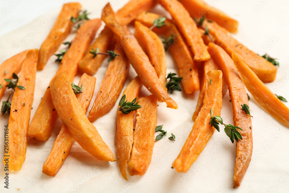 Tasty sweet potato fries on parchment, closeup Tasty sweet potato fries on parchment, closeup