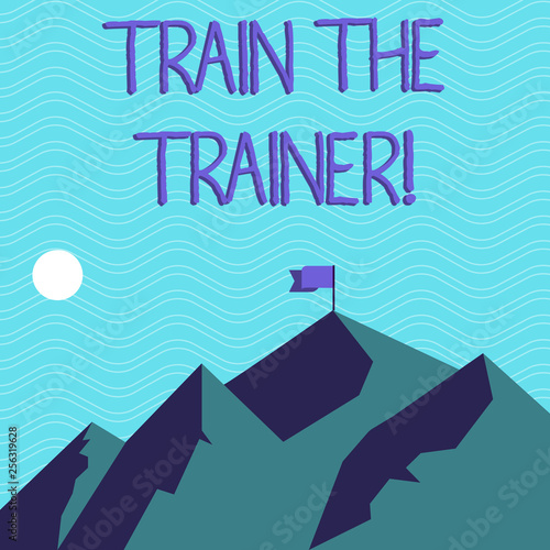 Text sign showing Train The Trainer. Business photo text Learning Technique Students being teachers themselves Mountains with Shadow Indicating Time of Day and Flag Banner on One Peak