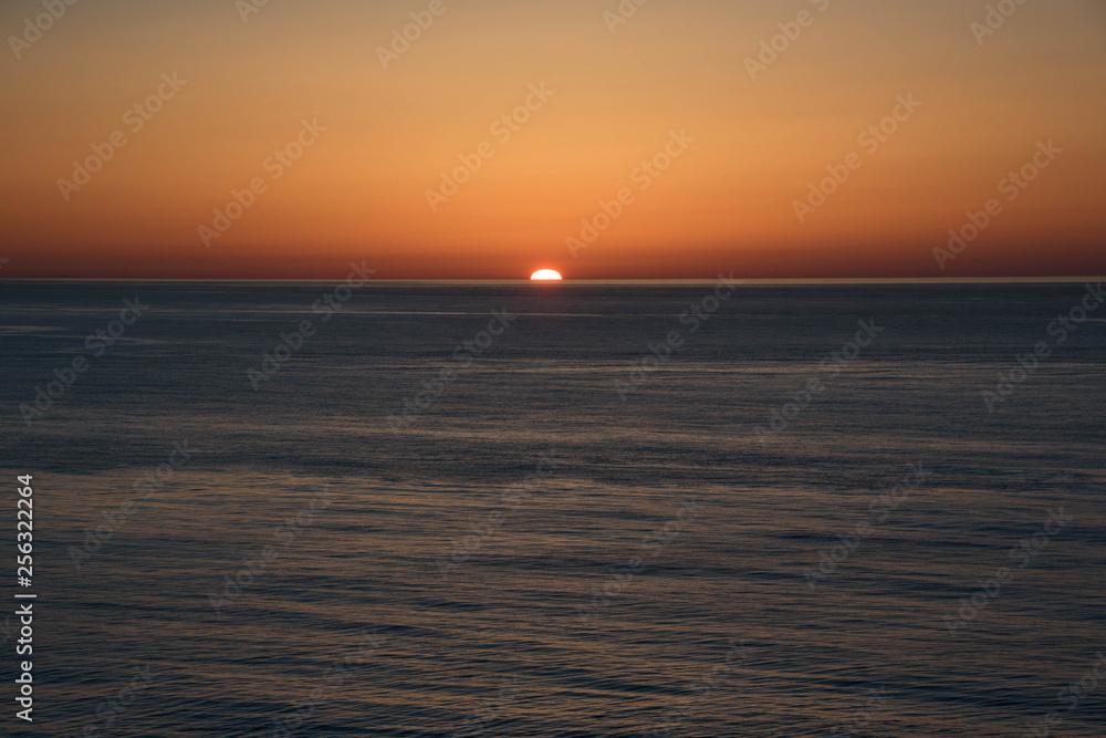 静かな海に沈む夕日