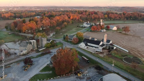 Aerial ascend to a high angle revealing Bushong's Mill / Zook's Flour Mill, Conestoga River, and dam, Lancaster County, Pennsylvania. Concept: Colonial America, the ​Industrial Revolution, water power photo