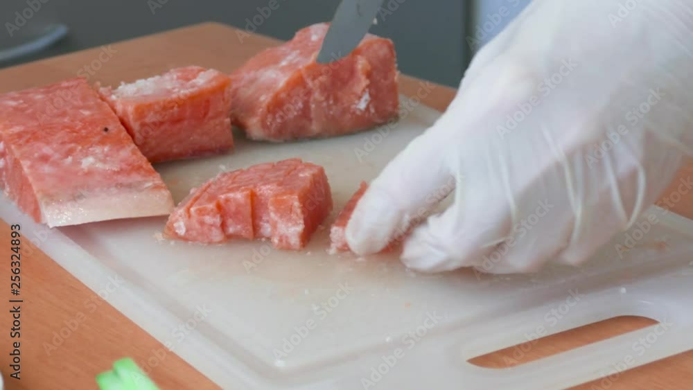 Chef cutting slices of salmon for sushi. Chef cutting slices of chum salmon for sushi rolls Chef cutting slices of salmon for sushi. Chef cutting slices of chum salmon for sushi rolls