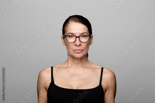 Portrait of serious mature woman wearing glasses photo