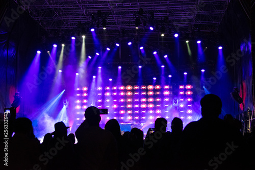 Group of people in outdoor concert, illuminated stage, high technology, powerful sound, latin america, fun, work, latin america.