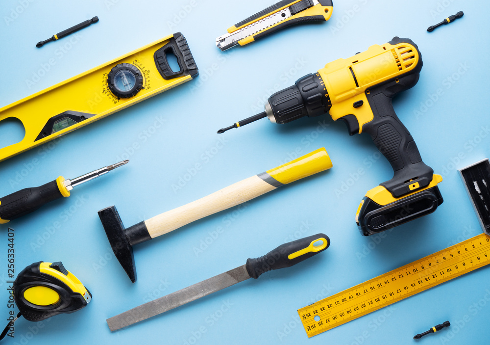 Creative provocation: a flat layout of yellow hand tools on a blue background. Creative provocation: a flat layout of yellow hand tools on a blue background.