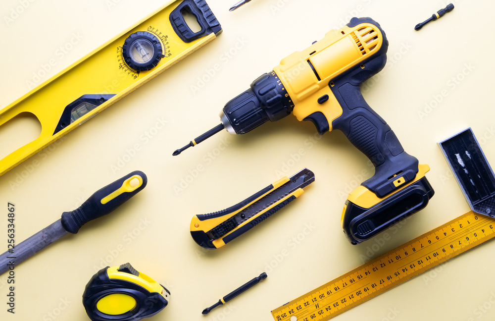 Flat layout of yellow hand tools on a yellow background. Flat layout of yellow hand tools on a yellow background.