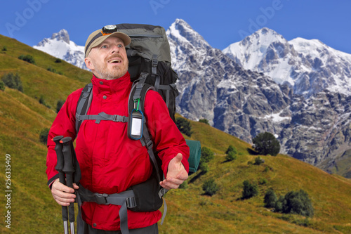 Happy tourist with backpack is traveling in the highlands