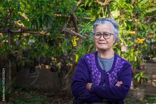 Portrait of a elderly woman in her garden. © meeboonstudio