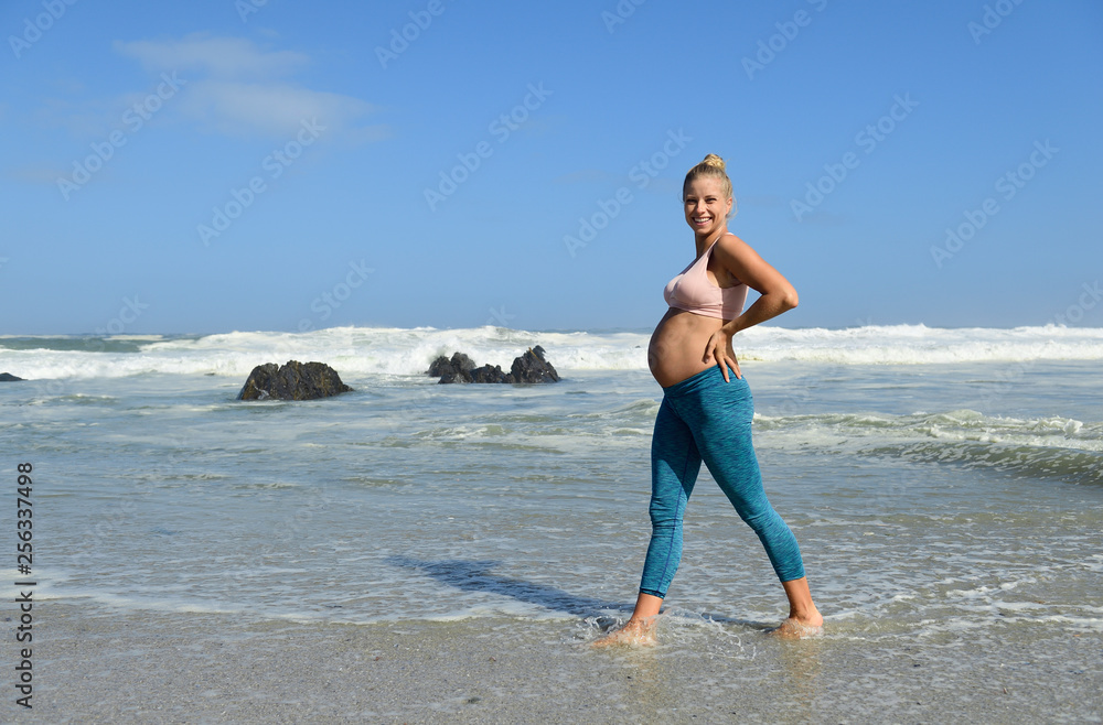 Portrait of happy pregnant woman on the beach wading in the sea Portrait of happy pregnant woman on the beach wading in the sea