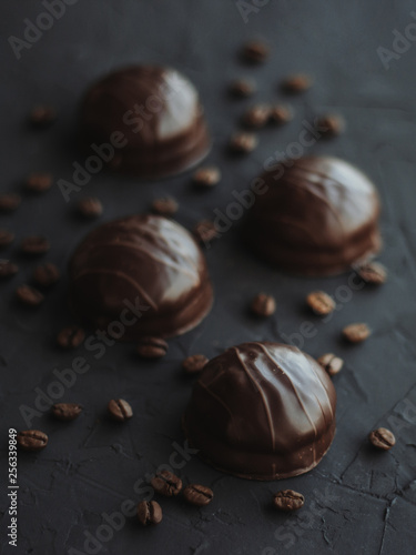 Chocolate cakes and coffee beans on a black background