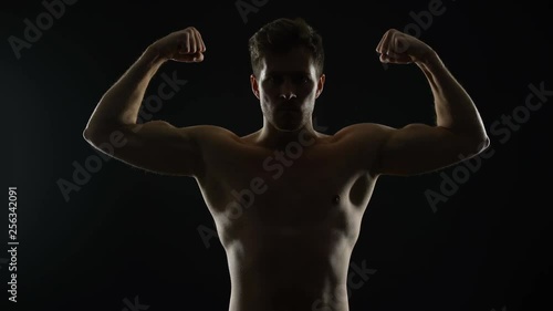Wallpaper Mural Strong masculine man showing biceps muscles, bodybuilding challenge, sports Torontodigital.ca