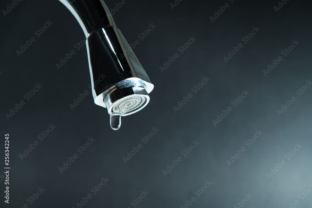world water day, water drop on faucet with black backgrounds world water day, water drop on faucet with black backgrounds