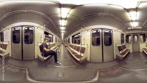 360 VR video. Inner view of moving subway train. Man commuter riding in almost empty carriage. Moscow, Russia