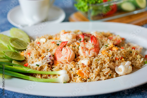 Quadro em tela Shrimp fried rice with Lime and Coriander on blue table whit White Coffee Cup an