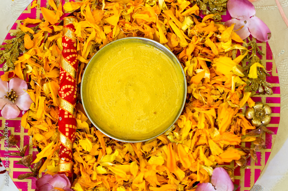 Traditional Haldi turmeric kept on a flower plate for the hindu ...