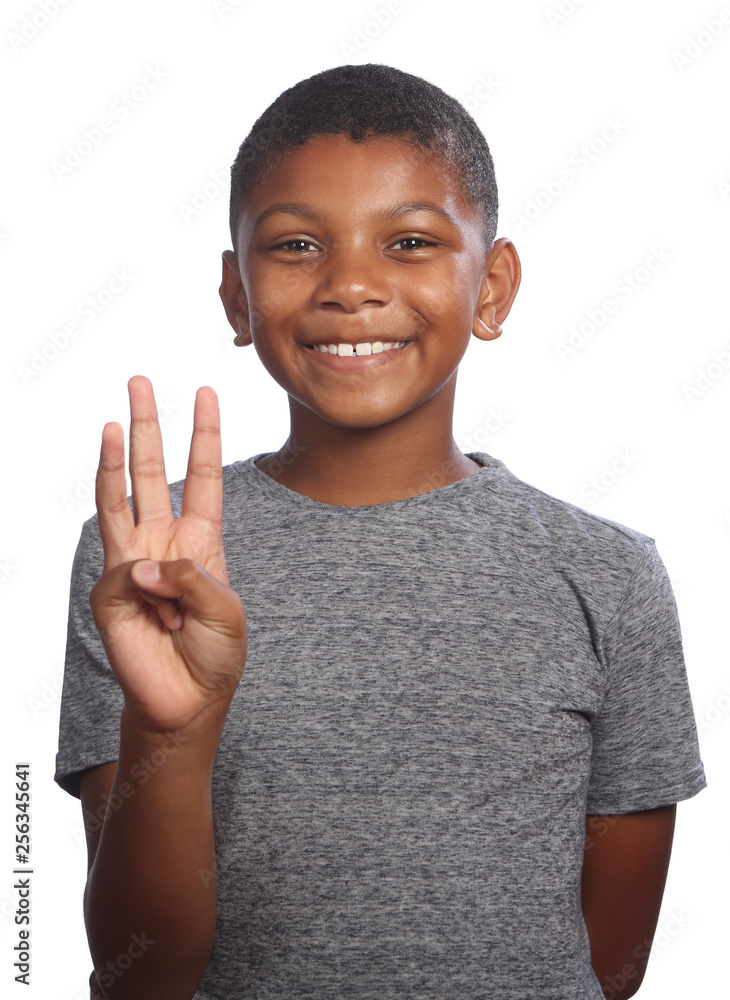 Smiling black boy showing number three on fingers Smiling black boy showing number three on fingers