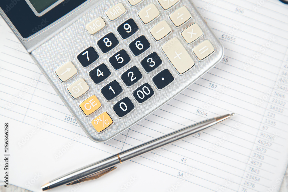 calculator with pen on document on desk calculator with pen on document on desk