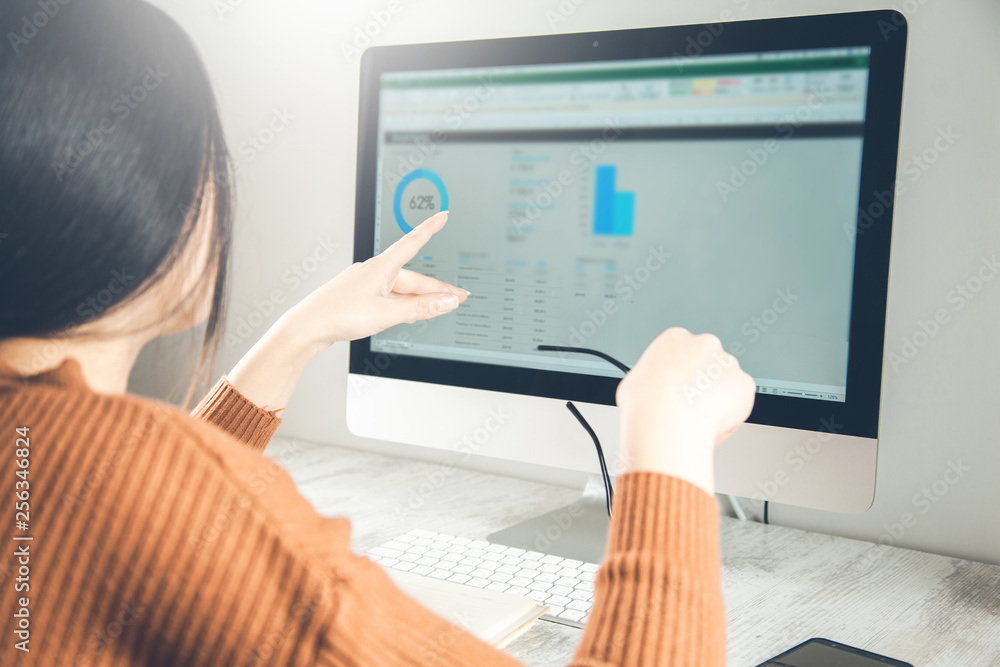 woman working in graph on computer screen woman working in graph on computer screen
