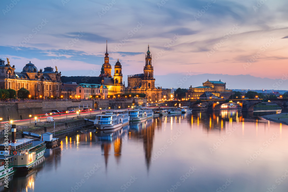 Incredible evening panorama of Cathedral of the Holy Trinity or Hofkirche, Bruehl's Terrace or The Balcony of Europe. Dramatic autumn sunset on Elbe river in Dresden, Saxony, Germany, Europe.