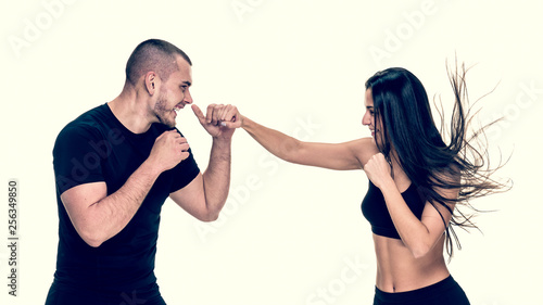 Fit athletic girl having kickboxing training with personal instructor, image with warm vintage toning